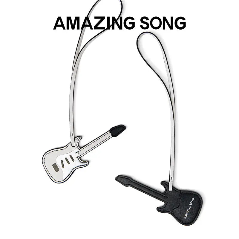 Amazing Song guitar-shaped bag charms in black and white on a white background