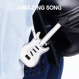 Amazing Song guitar-shaped bag tag on black handbag, stylish accessory close-up