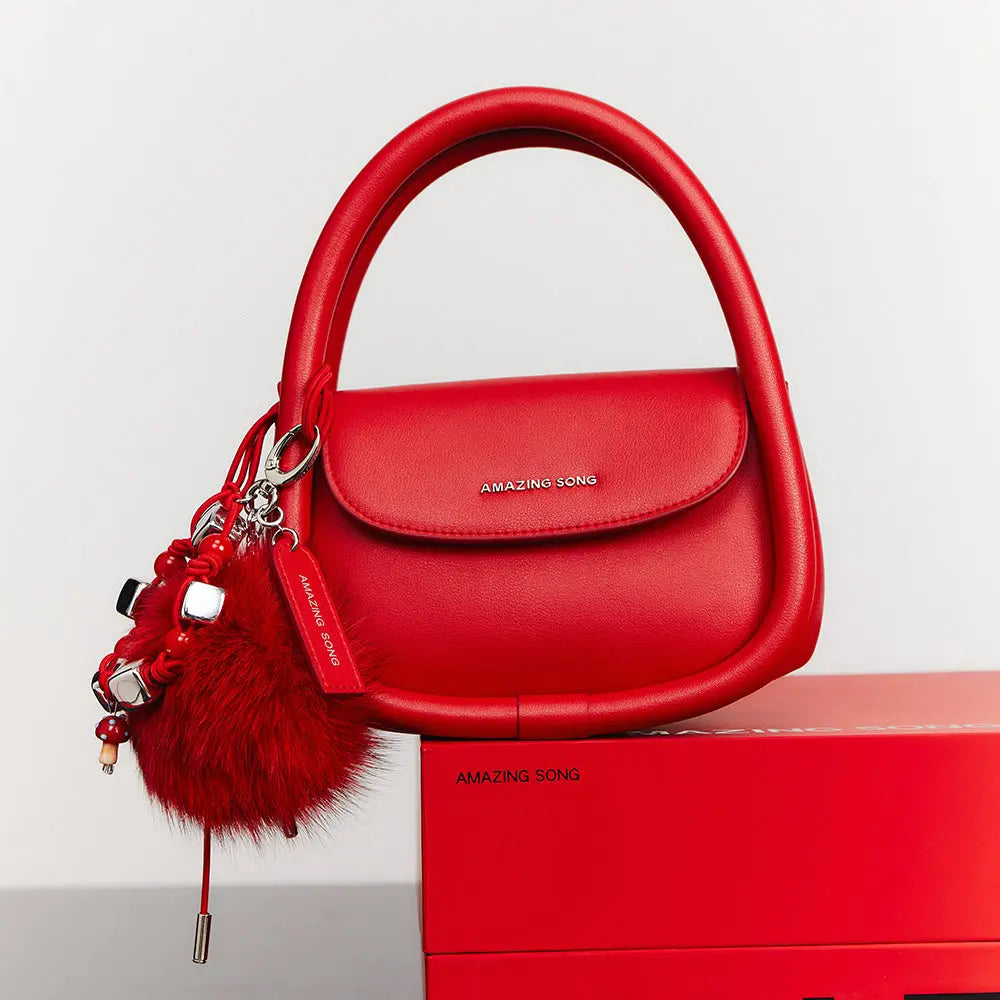 Amazing Song red handbag with fluffy keychain on branded red box