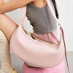 Woman with pastel colorblock dress holding pink Amazing Song shoulder bag