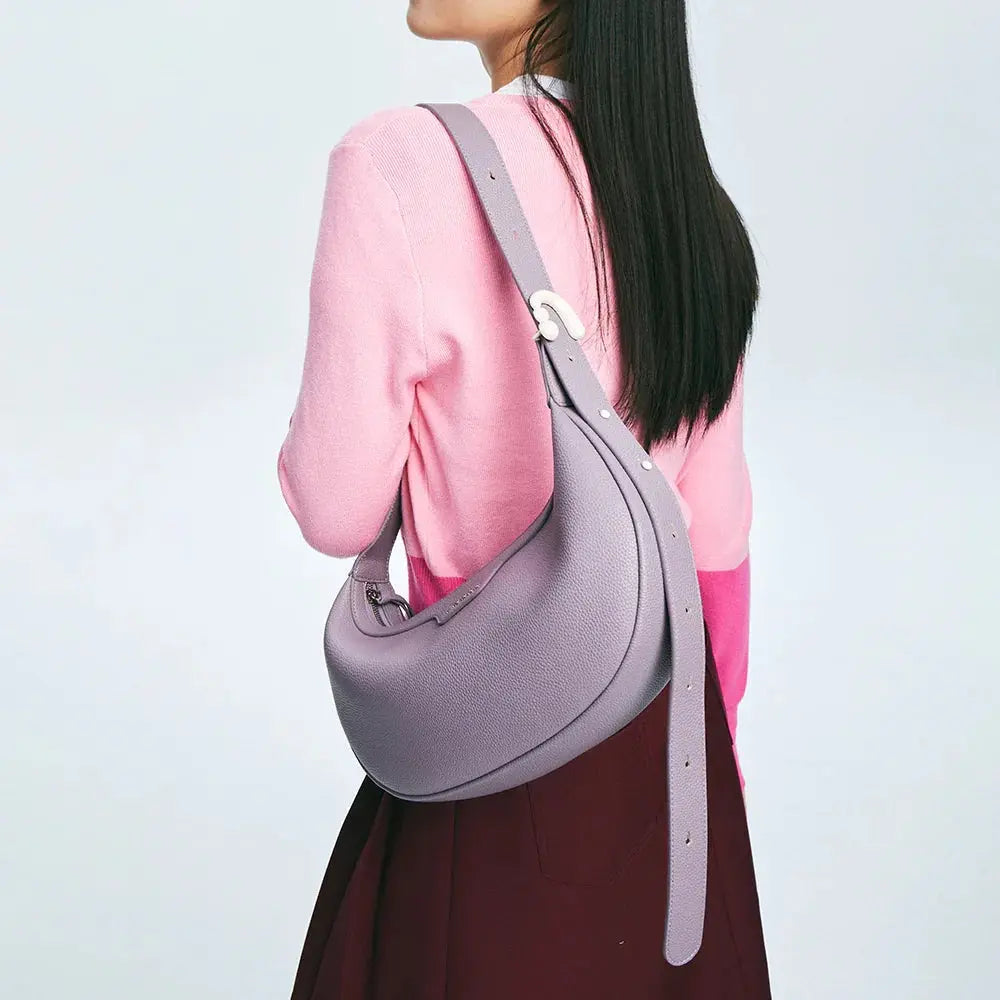 Woman in pink sweater carrying lilac leather shoulder bag, Amazing Song official website
