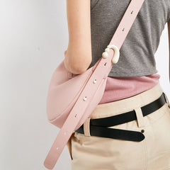 Woman wearing a light pink crossbody bag with adjustable strap, Amazing Song accessory