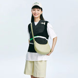 Smiling woman in casual outfit with abstract vest and cream crossbody bag, Amazing Song style