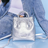 Metallic silver Amazing Song handbag with strap, styled with denim jacket and jeans