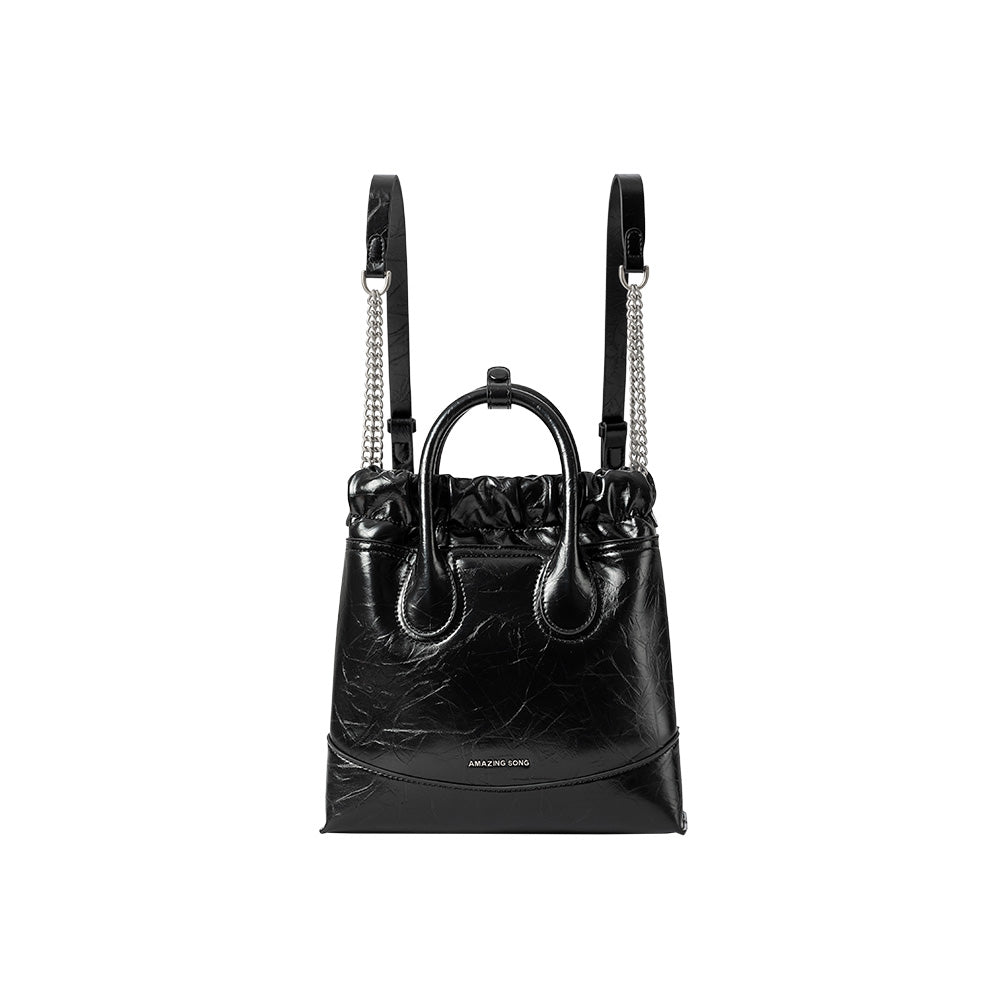 Amazing Song black leather handbag with chain straps and top handle, isolated on white