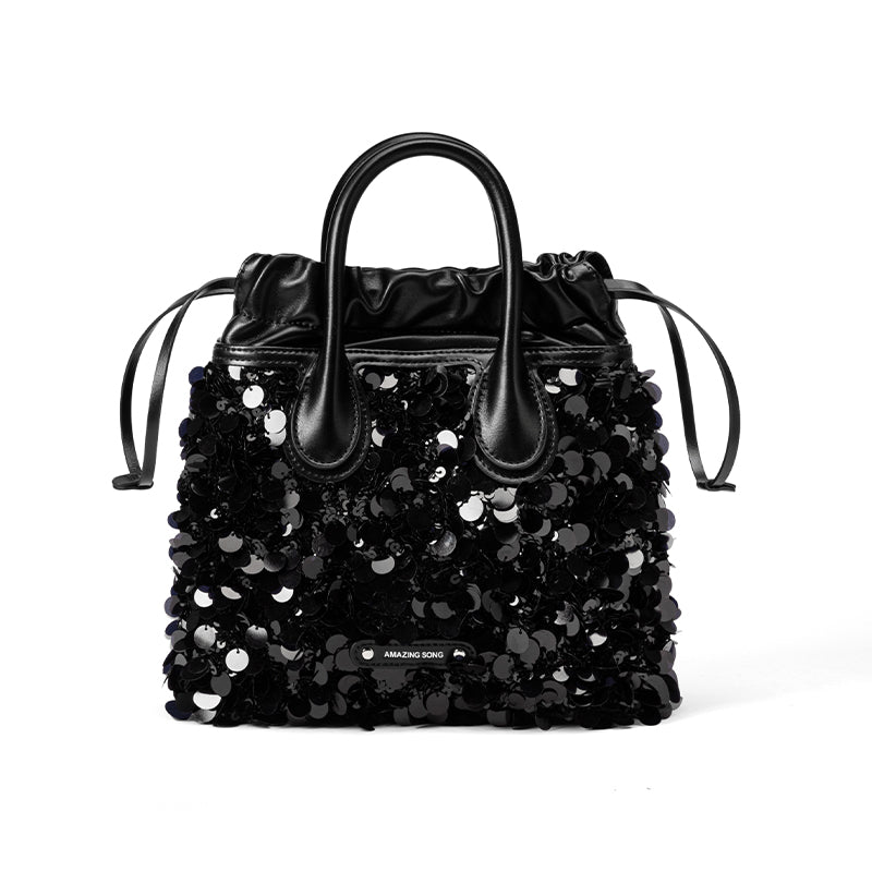 Amazing Song black sequin embellished handbag with leather handles on white background