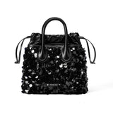 Amazing Song black sequin embellished handbag with leather handles on white background