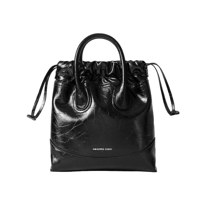 Amazing Song black leather tote bag with drawstring handles on white background
