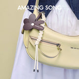Amazing Song yellow shoulder bag with flower keychain and braided rope detail