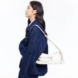 Woman in blue embellished denim jacket carrying a white shoulder bag, Amazing Song