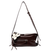 Dark brown leather shoulder bag with front zipper and white flower accent, Amazing Song
