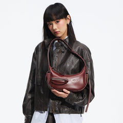 Woman in dark leather jacket holding a brown designer handbag, Amazing Song fashion