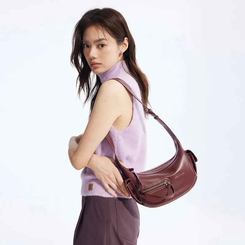 Woman in lilac sleeveless top with burgundy shoulder bag, Amazing Song fashion accessory