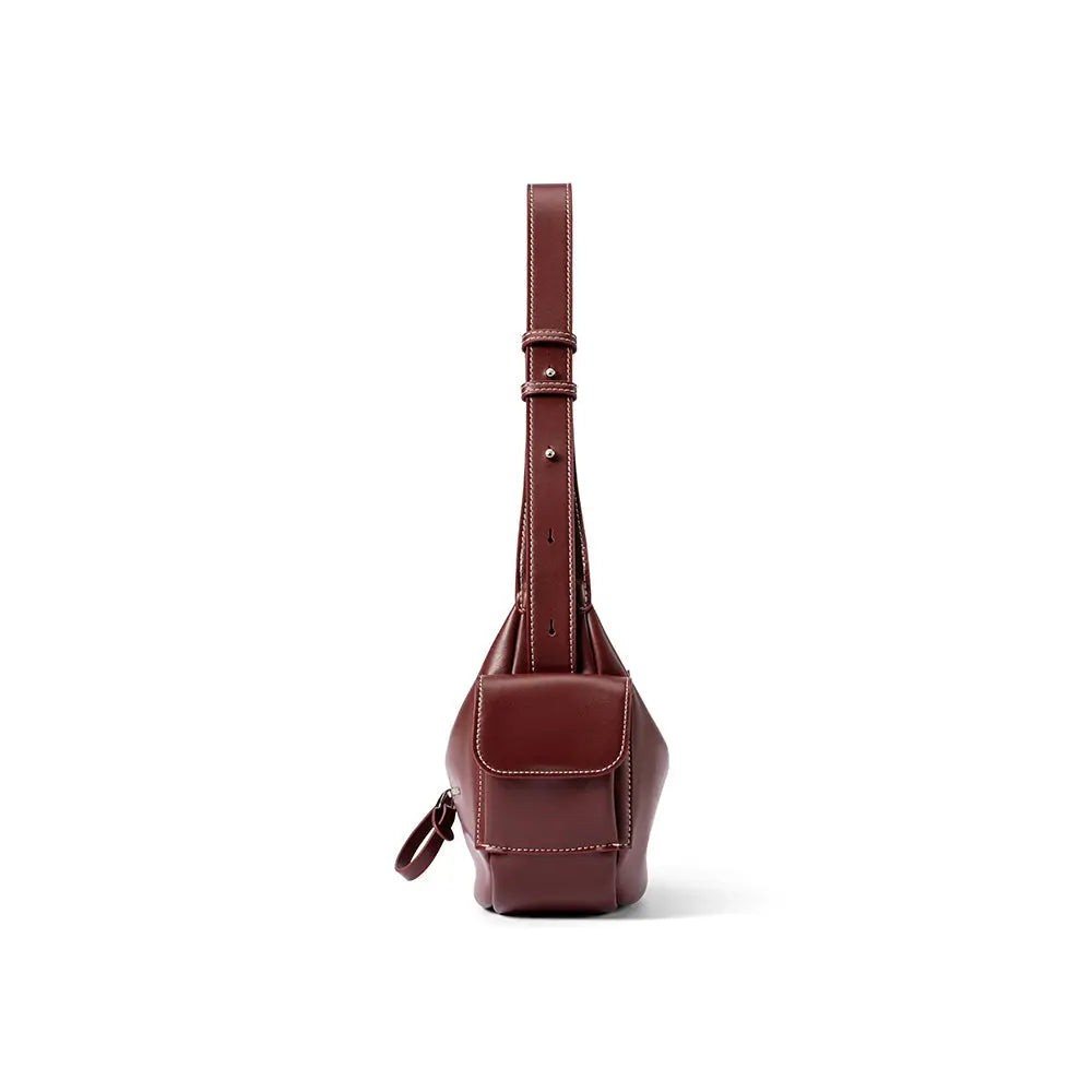 Front view of a brown leather sling bag with white stitching, Amazing Song website product.