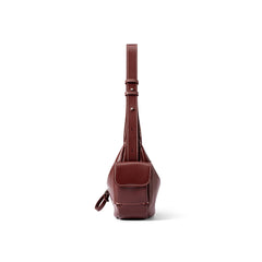 Front view of a brown leather sling bag with white stitching, Amazing Song website product.