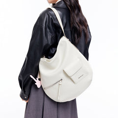 Woman wearing a black leather jacket with an Amazing Song white shoulder bag