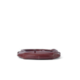 Flat lay view of maroon leather bag with white stitching from Amazing Song official website