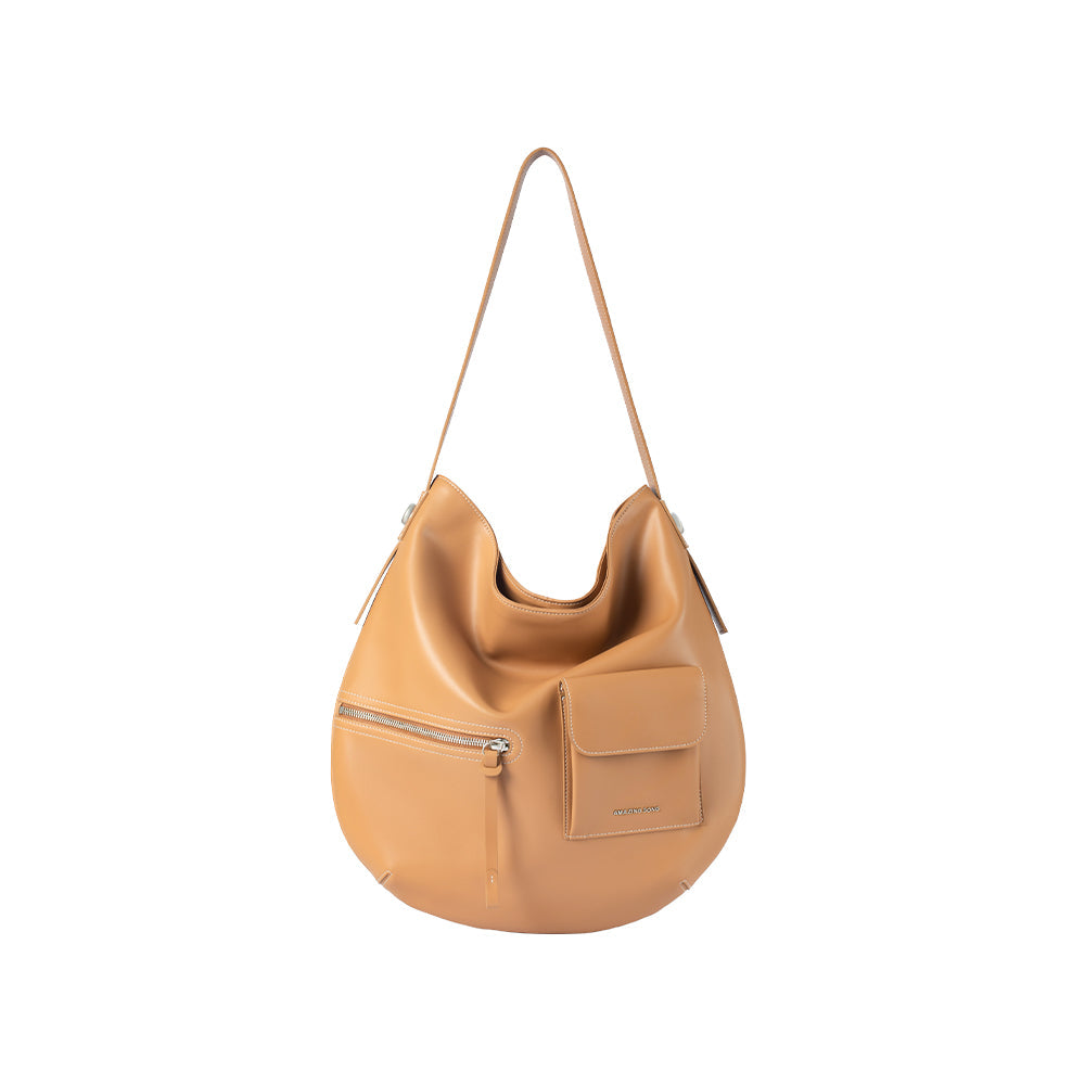 Tan leather shoulder bag with front pockets, featured on Amazing Song official website