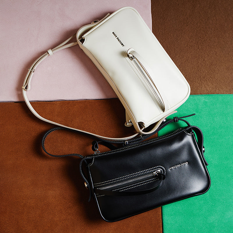 Amazing Song black and white leather handbags with zippers on colorful background