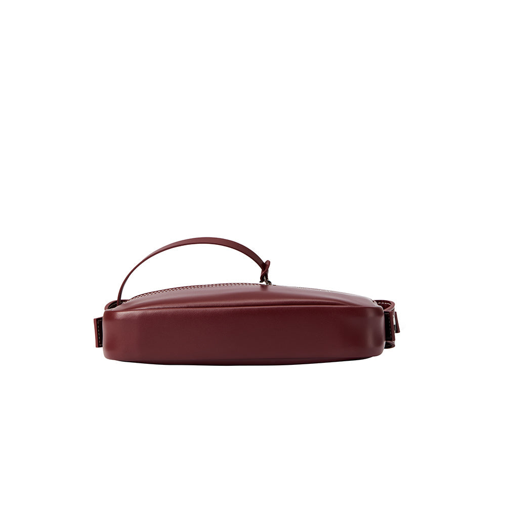 Amazing Song maroon leather handbag with handle, shown from the side on white background