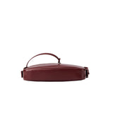Amazing Song maroon leather handbag with handle, shown from the side on white background