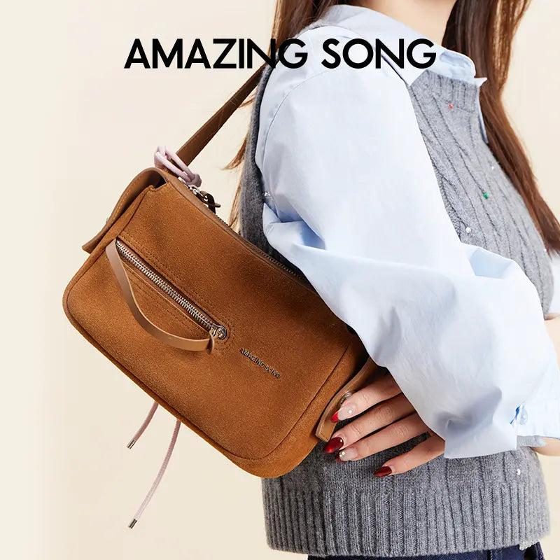 Woman holding brown Amazing Song handbag, casual fashion, official Amazing Song website