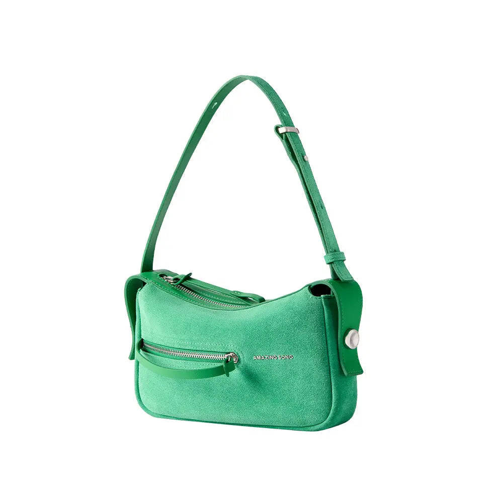 Amazing Song green suede shoulder bag with front zipper and silver logo on white background