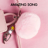 Pink fluffy pom pom keychain and handbag accessory on pink background, Amazing Song brand