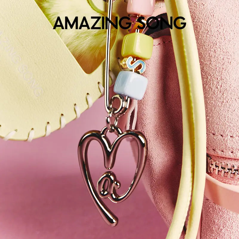 Amazing Song pastel beaded keychain with heart charm on pink purse background