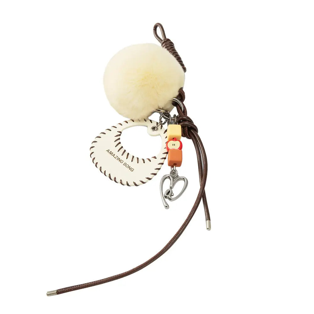 Amazing Song keychain with fluffy pompom, heart-shaped charm, and leather strap