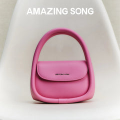Amazing Song pink handbag on white chair, modern purse fashion accessory