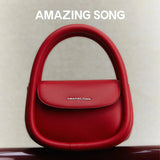 Amazing Song red handbag with top handle on neutral background, official website promo