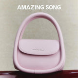 Amazing Song pink handbag with curved handle on neutral background