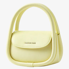 Pastel yellow Amazing Song handbag with curved handle on white background