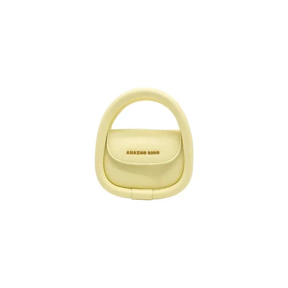 Amazing Song yellow mini handbag with rounded handle on white background