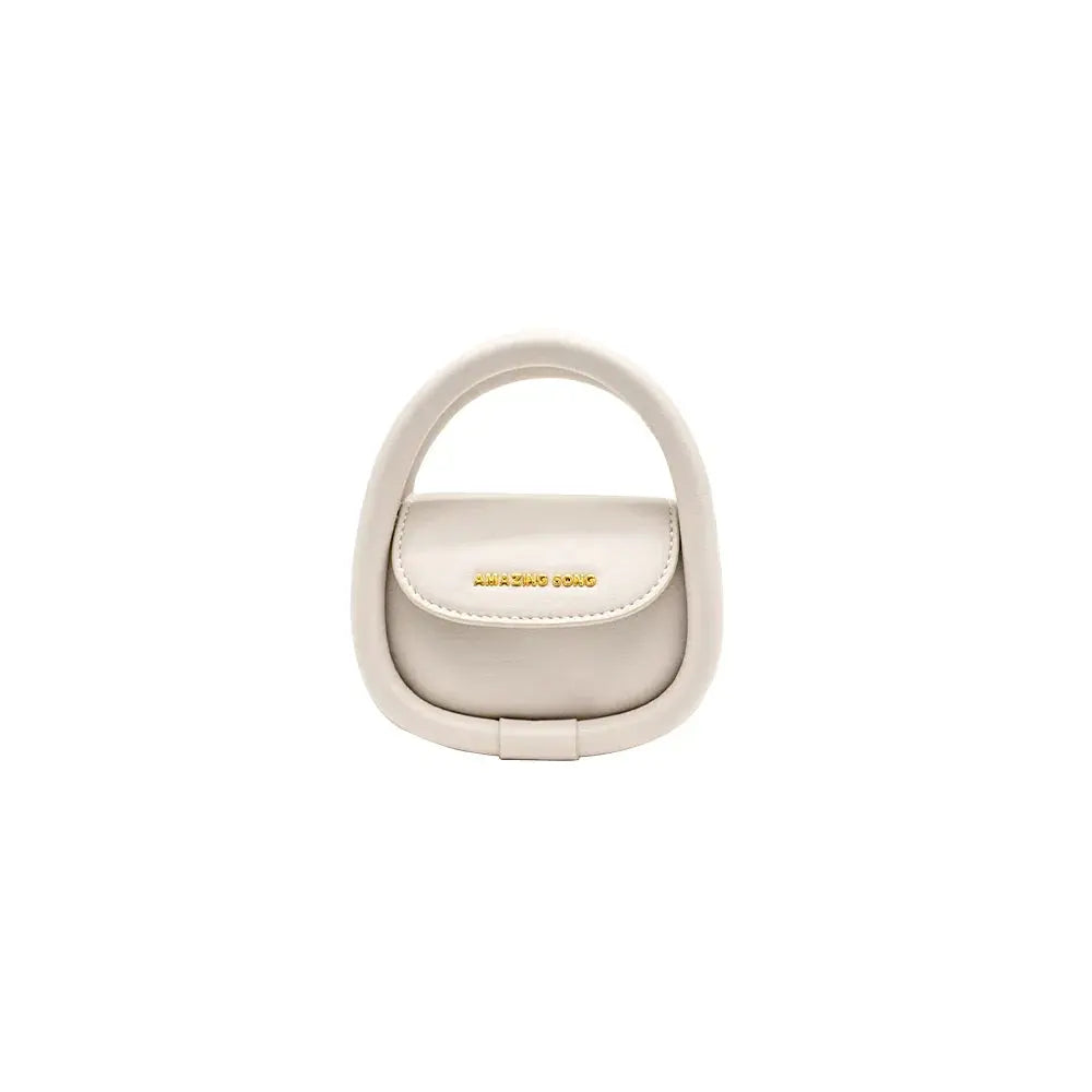 Amazing Song beige mini handbag with unique oval handle on white background
