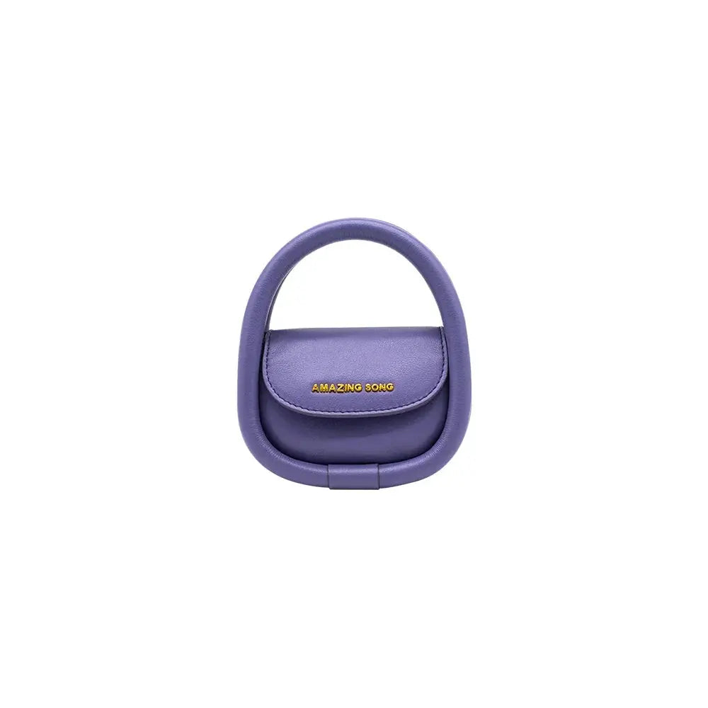 Amazing Song purple designer handbag with circular handle on white background