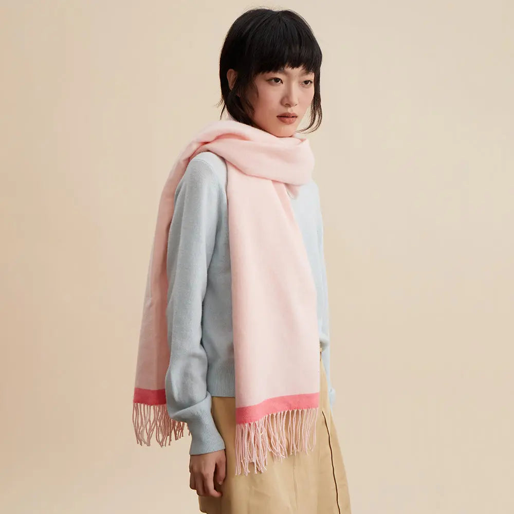Woman wearing a pale pink fringe scarf and light blue sweater, Amazing Song fashion