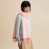 Woman wearing a pale pink fringe scarf and light blue sweater, Amazing Song fashion