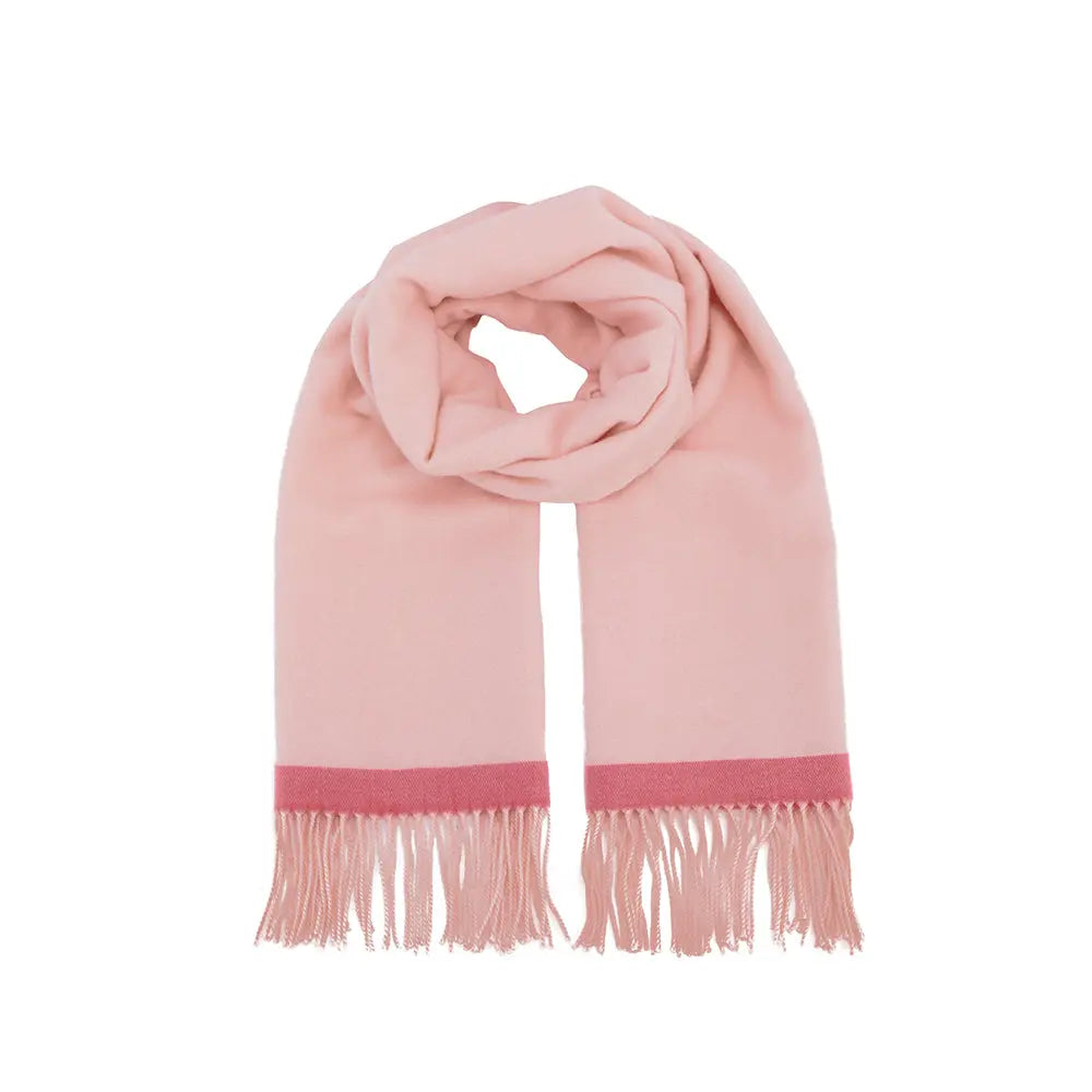 Soft pink scarf with red trim and fringed ends, folded on white background