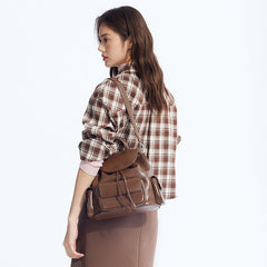 Woman wearing plaid shirt with brown leather backpack, Amazing Song fashion style