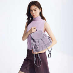 Woman in sleeveless lavender top holding a light purple backpack, Amazing Song style