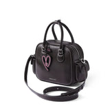 Black Amazing Song handbag with pink heart charm, double handles, and white stitching