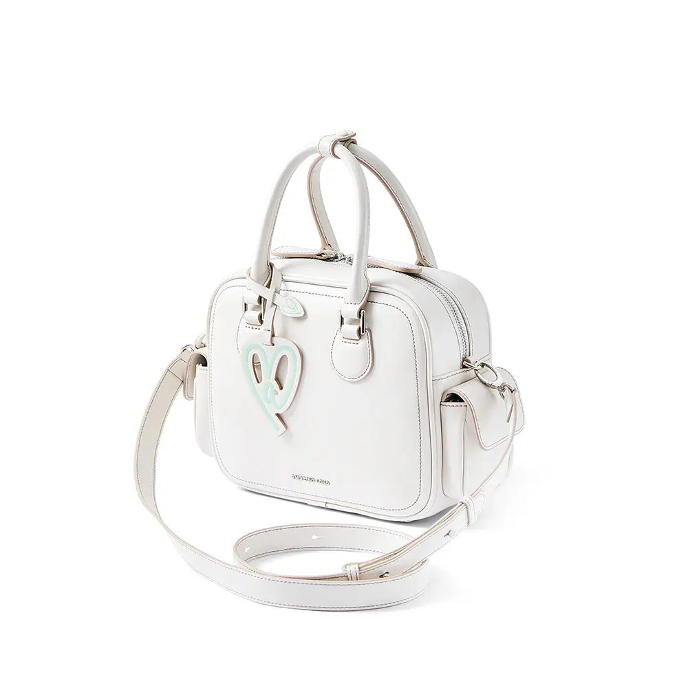 White square handbag with double handles, mint heart accent, and Amazing Song logo
