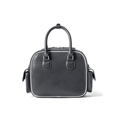 Black leather handbag with top handles, side pockets, and white trim, Amazing Song brand