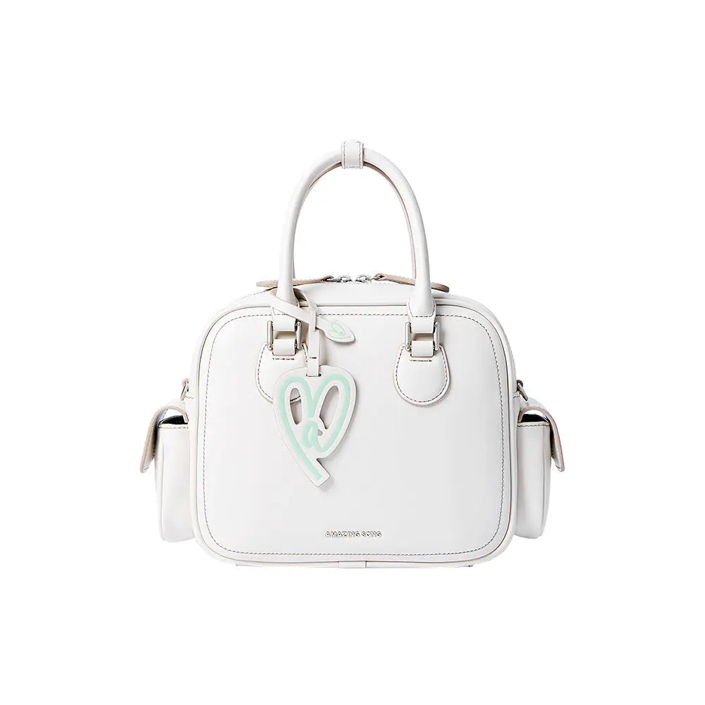 White Amazing Song handbag with top handles and pastel heart charm, front view
