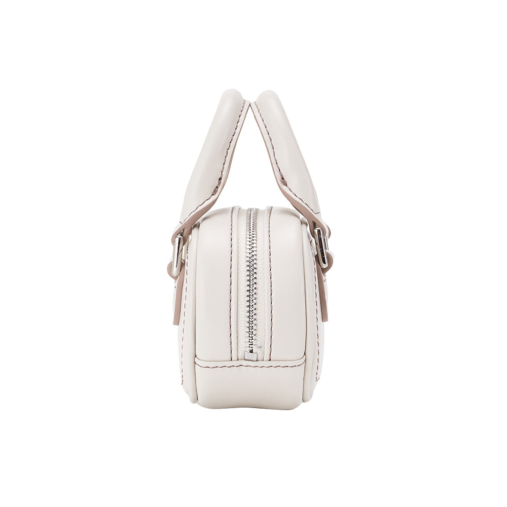 Side view of white leather handbag with top handles and silver zipper, Amazing Song