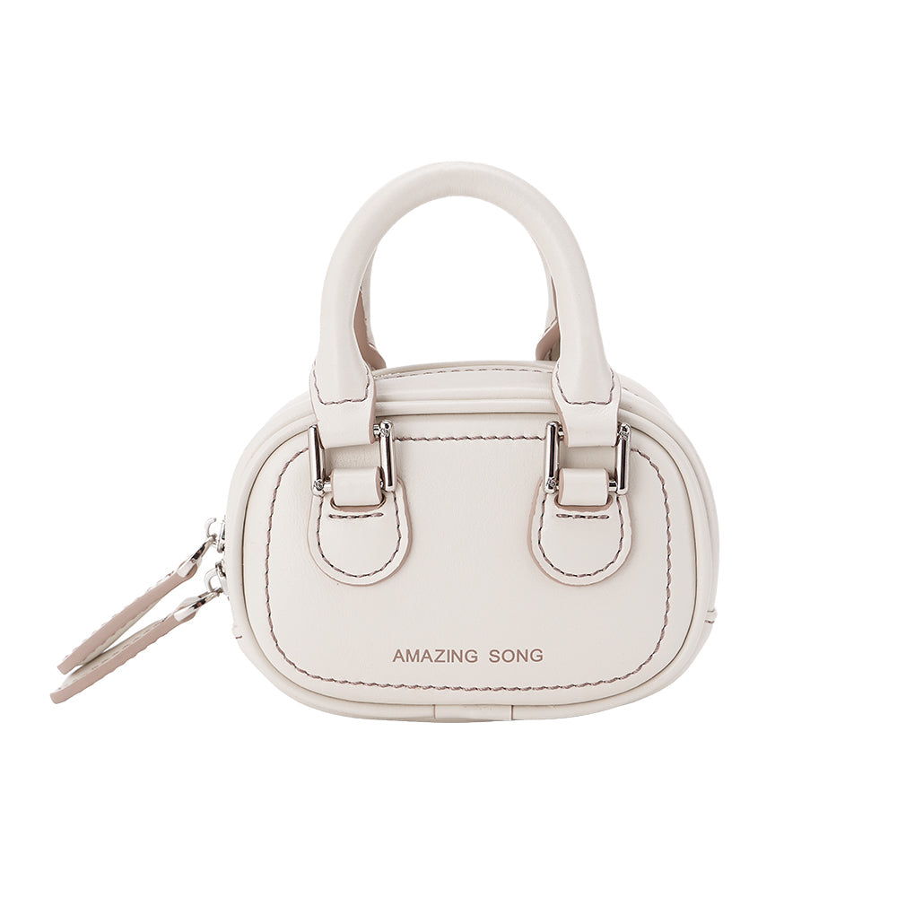 White mini handbag with double handles and 'AMAZING SONG' logo on front, product photo