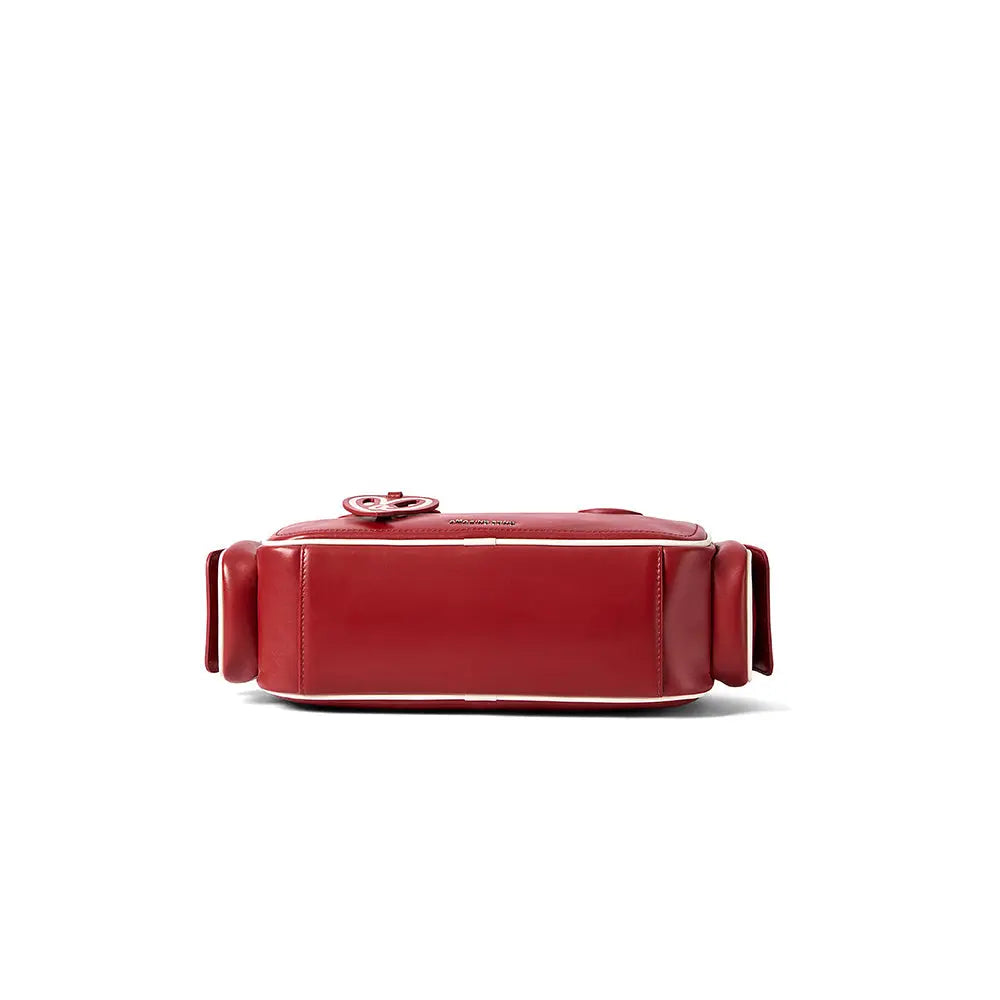 Red leather handbag with sleek design on white background, Amazing Song official website