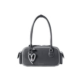 Amazing Song black handbag with heart keychain and double handles on white background